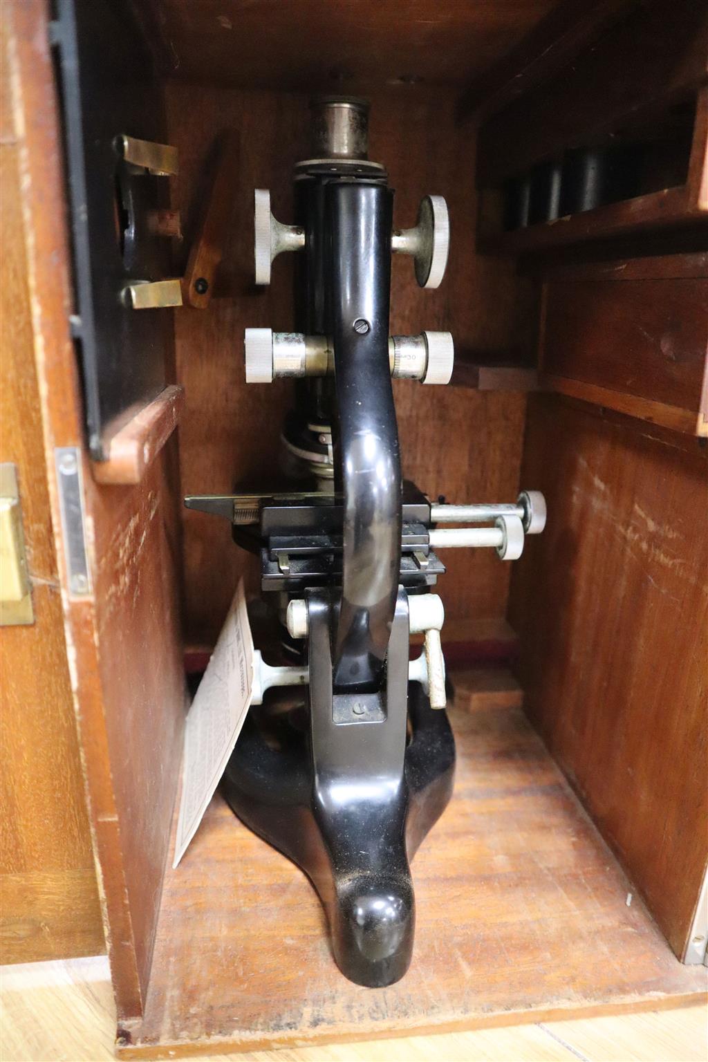 Three various cased microscopes